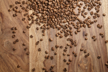 coffee beans scattered over wood background from above, background photo