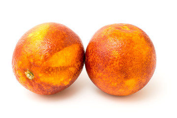 Two red tangerine on a white