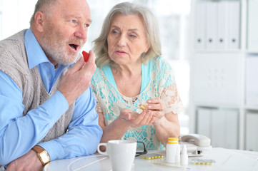 Elderly couple with pills
