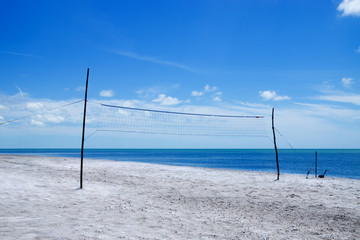 A beach volleyball net on the beach.