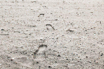 Human footprints in gray sandy ground