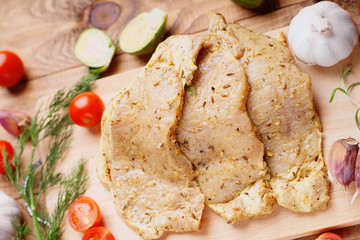 Raw marinated pork meat and vegetables