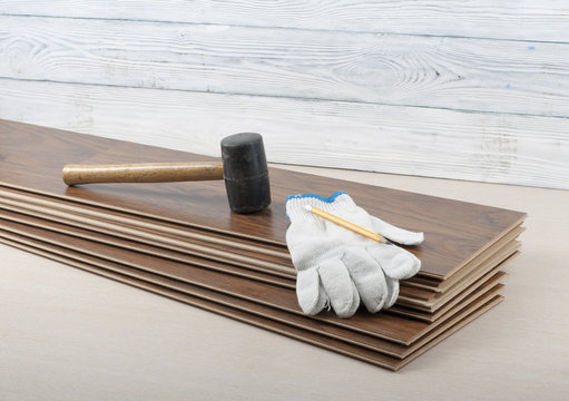 Carpentry concept.Different tools and gloves on the new laminate flooring.Copy space for text.