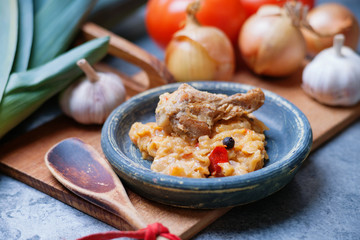Canned stewed meat, vegetables, vintage plate and wooden spoon 
