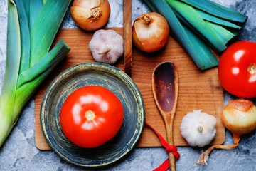 Vegetables mix, vintage plate and wooden spoon 
