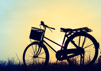 Fototapeta na wymiar beautiful landscape image with silhouette Bicycle at sunset