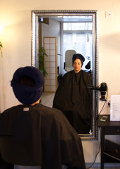 Fototapeta na wymiar hairdresser, look in the mirror, cut, cut their hair