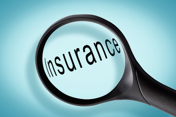 Word insurance seen through a magnifying glass, insurance concept