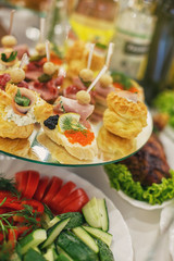 decorated catering banquet table with different food snacks