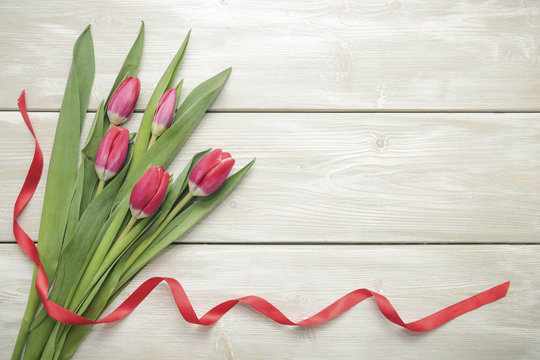 Bouquet of tulips on wooden background