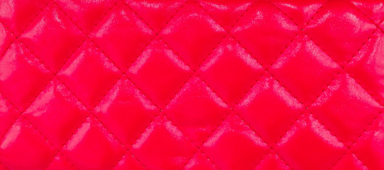 Leather texture  with seamless sewing  thread diamond square shape pattern in red color for background.