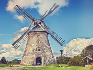 Fototapeta na wymiar Old windmill at a sunny day, countryside in Europe