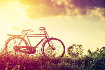 Fototapeta na wymiar beautiful landscape image with classic Bicycle at sunset