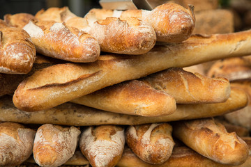 Fototapeta na wymiar French bread baguettes from bakery. Selective focus. Fresh bred and baguettes background