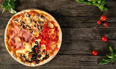 Tasty pizza on a wooden background.