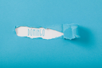 Domingo (Portuguese/Spanish Sunday) weekday message on Paper torn ripped opening