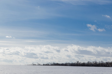 Spring sky over the snowy plain.