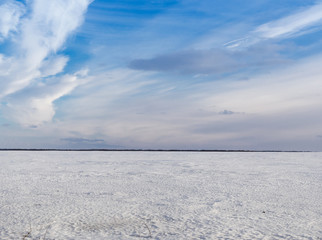 Spring sky over the snowy plain.