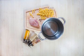 Ingredients cooking chicken fillet pasta wooden background top view