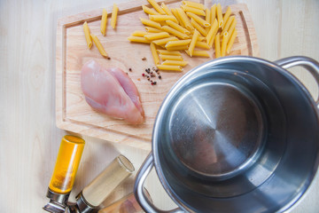 Fototapeta na wymiar Ingredients cooking chicken fillet pasta wooden background top view