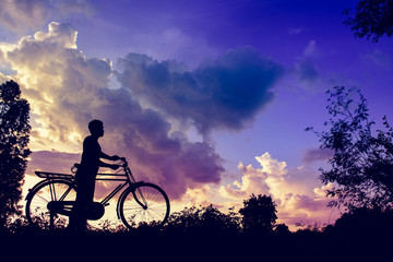 vintage bicycle with biker man silhouette at sunset image