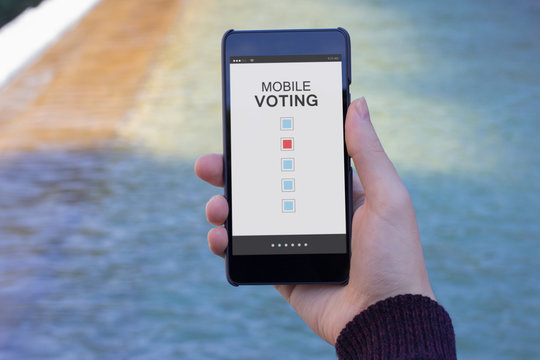Man holding mobile with water on the background and voting online
