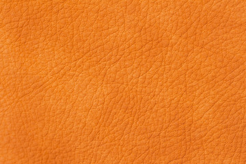 Texture of genuine leather close-up, cowhide, orange. For natural, artisan backgrounds, backdrop, substrate composition use