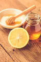 Lemon slice with honey on wood table