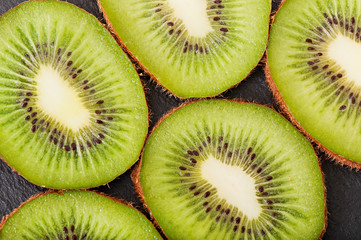 Kiwi fruit on a dark background, food.