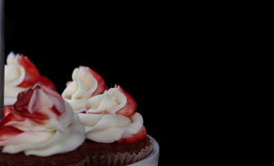 Lot of a cupcakes, on a black background