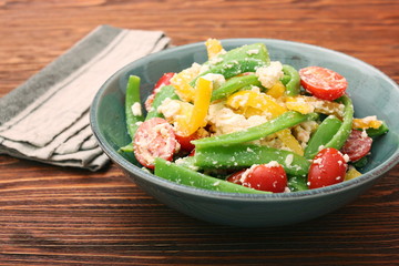 Snow pea salad with feta, tomato and pepper