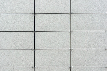 Wall coated with facing panels. Architectural background.