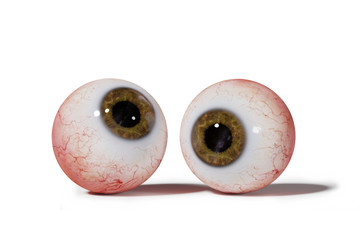 two realistic human eyeballs with brown iris isolated on white background