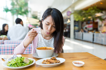 Woman enjoy her meal in restaurant