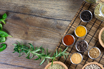 bowls of various dip sauces on black background, top view