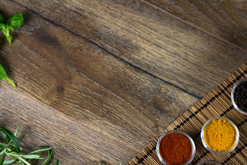 bowls of various dip sauces on black background, top view