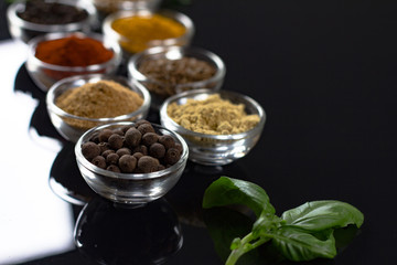 bowls of various dip sauces on black background, 