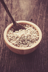 organic millet in a wood bowl on wooden rustic table