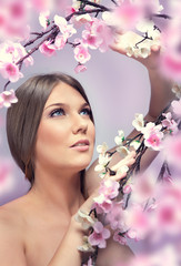 Fototapeta premium young woman with spring flowers
