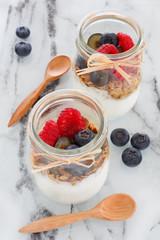 Healthy breakfast. Granola with yogurt and berries. Yogurt with blueberries and raspberries in a jar