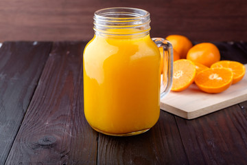 Orange juice on wooden background