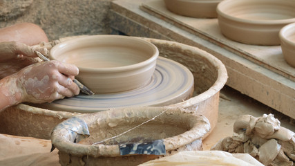 Young woman hands working on pottery wheel