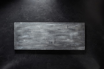 wooden signboard at black background