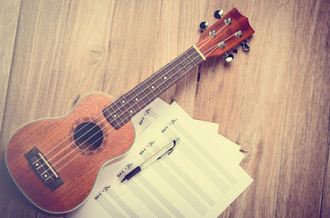 Ukulele and musical paper notes