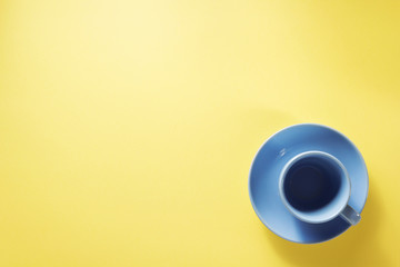 cup and saucer at yellow background