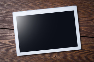 Modern digital tablet on wooden table