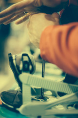 Snowboard repair shop worker adjust the bindings