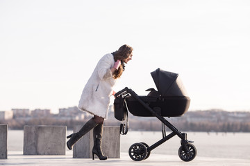 young mother with a stroller walking