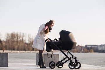 young mother walking with baby, good weather for walking, healthy lifestyle