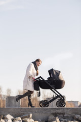 Obraz premium young mother walking with baby, good weather for walking, healthy lifestyle